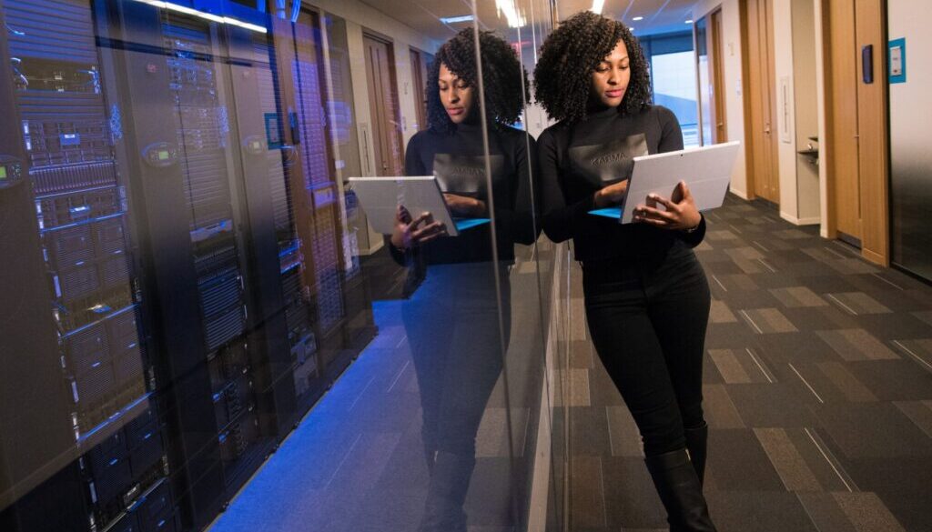 woman in black top using MacBook