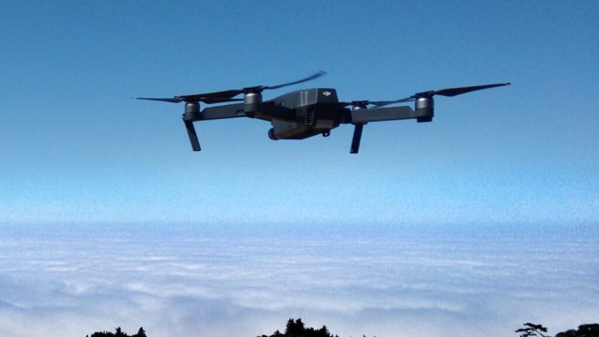 black drone on air over cloudy sky at daytime