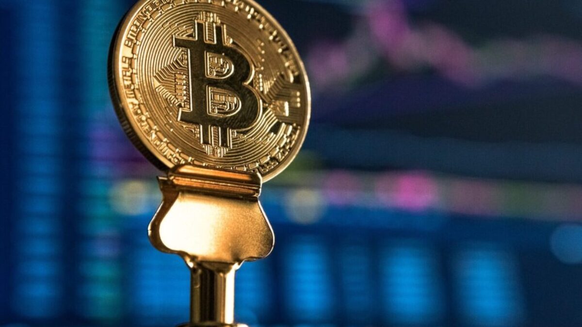 selective focus photo of Bitcoin near monitor