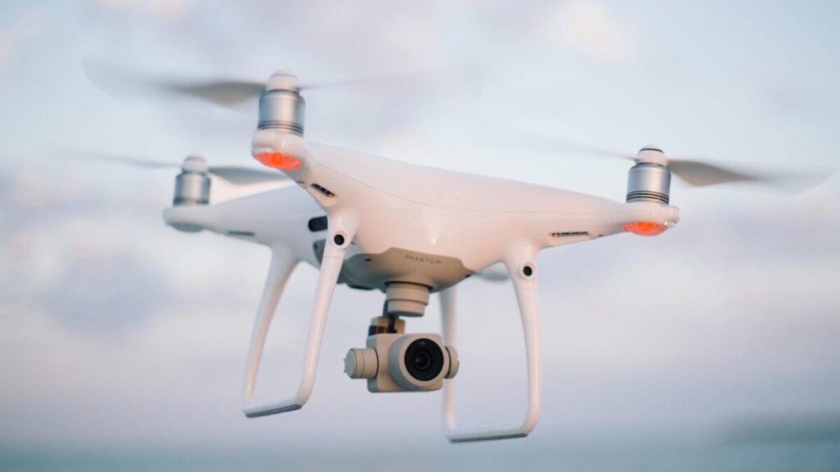 close up photography of drone flying over body of water at daytime