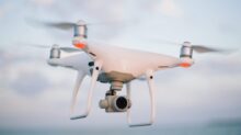 close up photography of drone flying over body of water at daytime