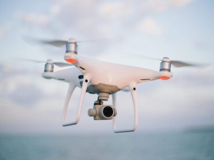 close up photography of drone flying over body of water at daytime
