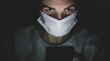 man in white face mask