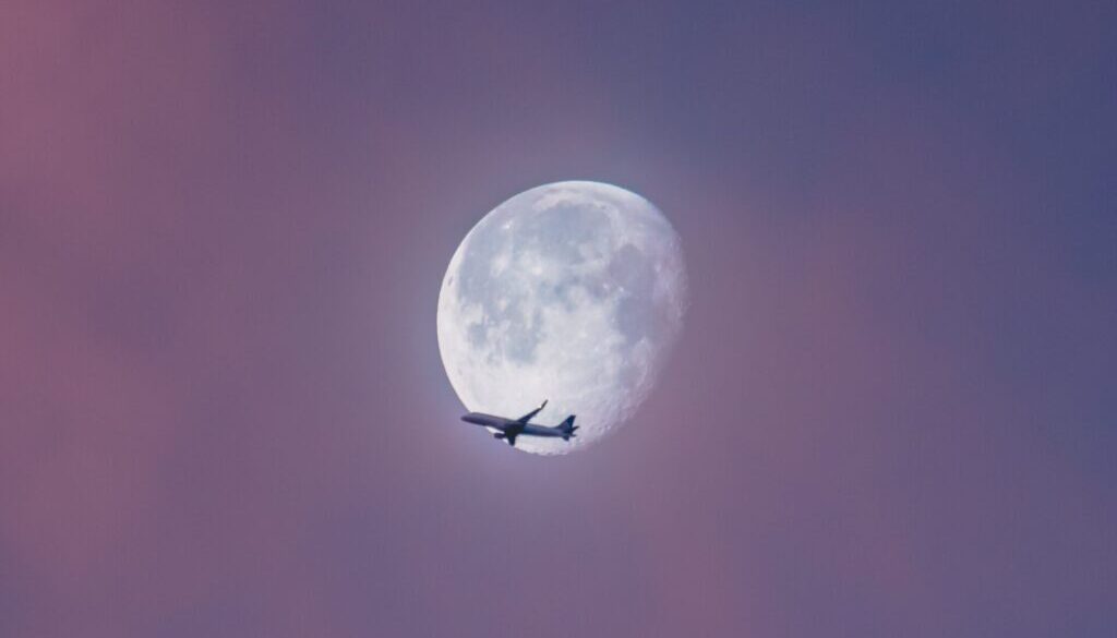 Ian Simmonds / Unsplash.com flying plane at sky during full moon at daytime