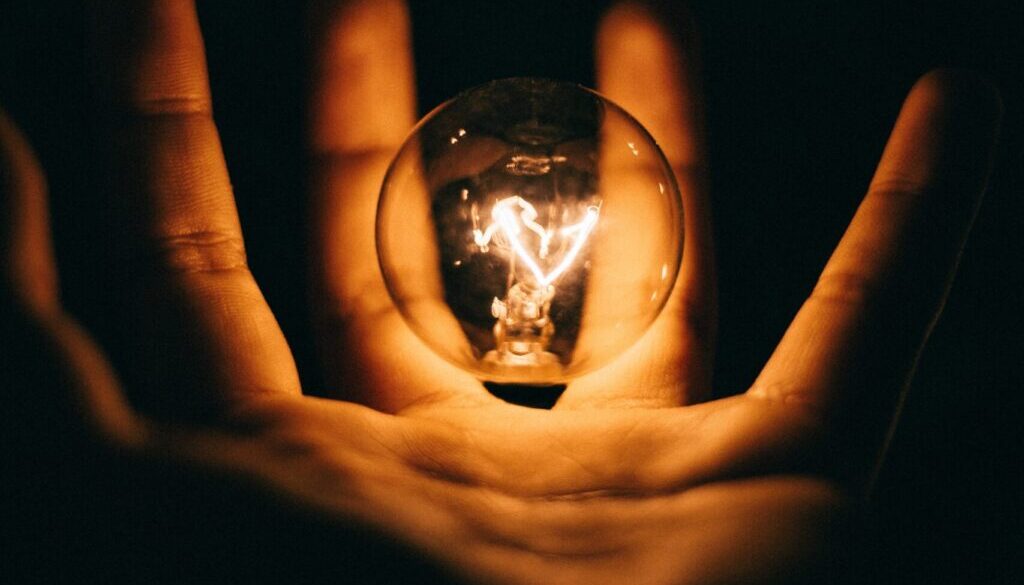 Rohan Makhecha clear glass bulb on human palm