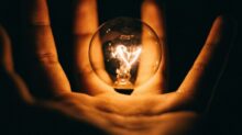 clear glass bulb on human palm