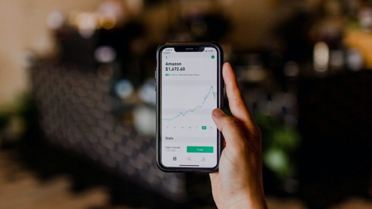 person holding black iPhone displaying stock exchange