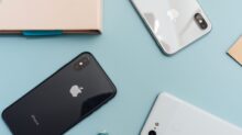 space gray iPhone X on blue surface