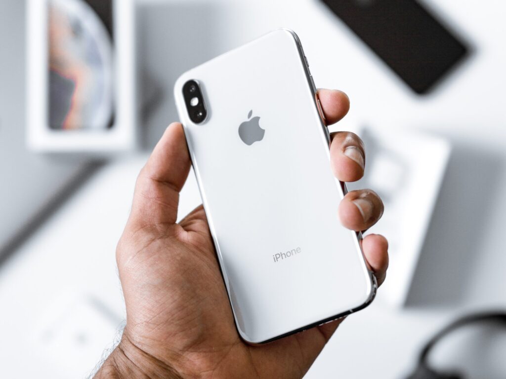 Photo By Kevin Bhagat person holding silver iPhone X