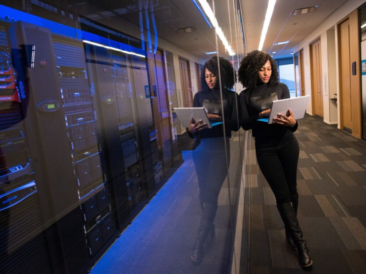 woman in black top using MacBook