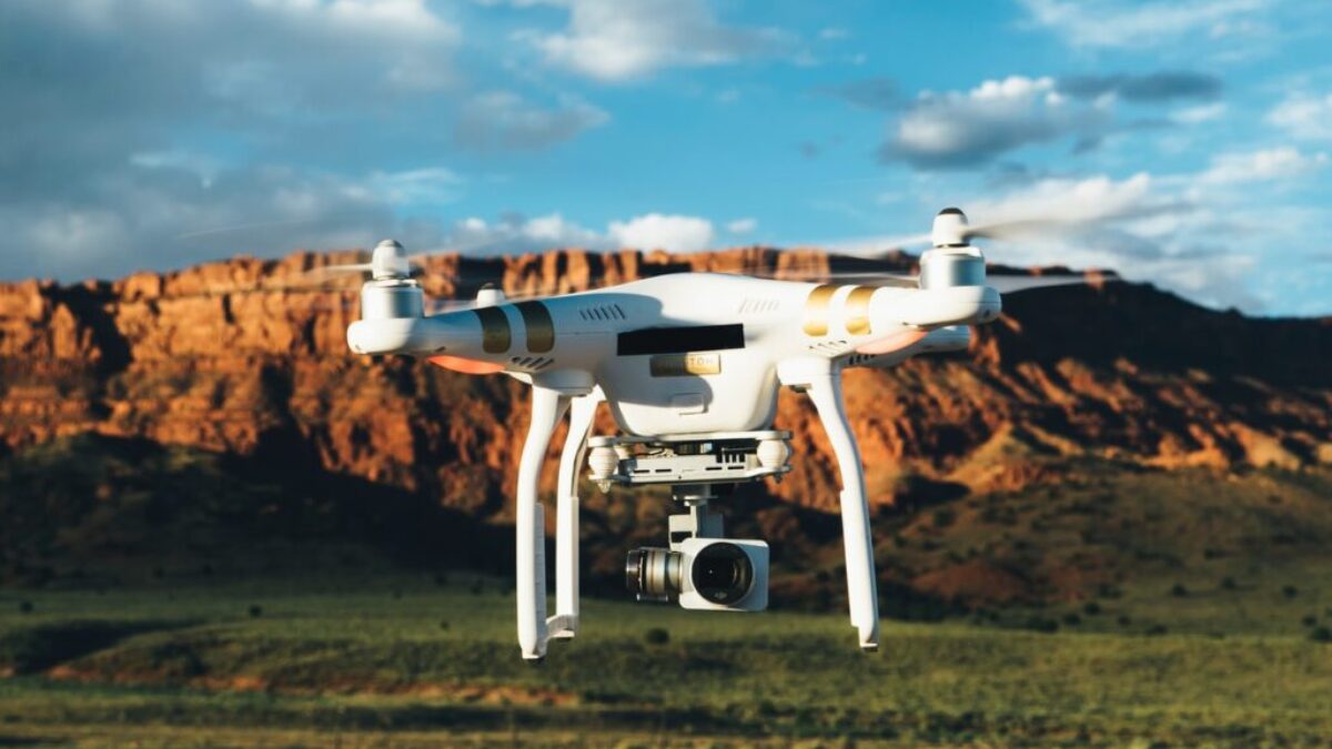 landscape photography of DJI Phantom flying midair in front of mountain