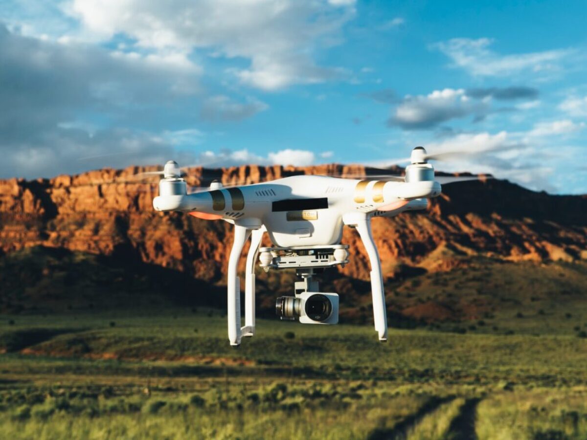 landscape photography of DJI Phantom flying midair in front of mountain