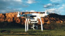 landscape photography of DJI Phantom flying midair in front of mountain