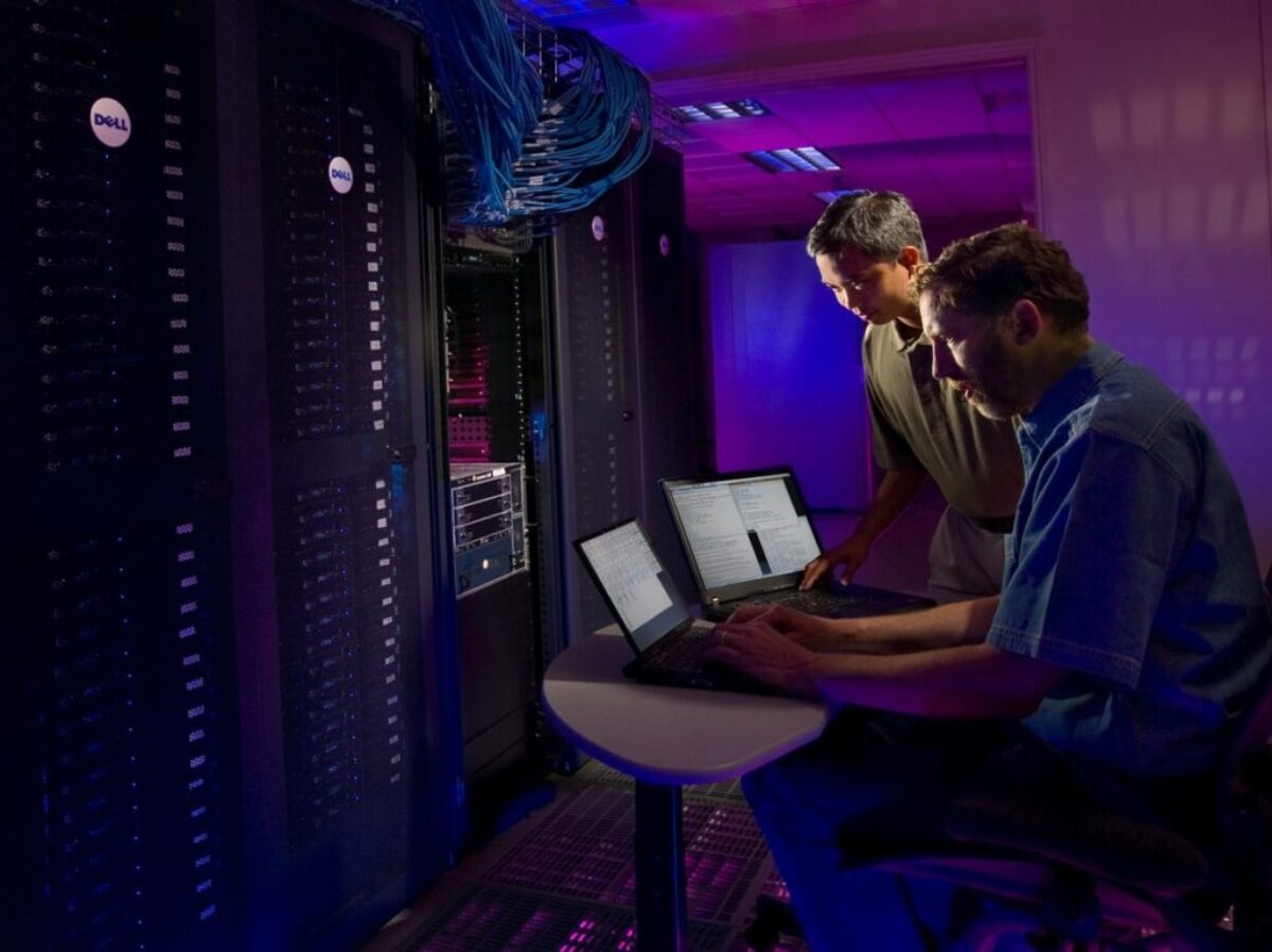 woman in blue long sleeve shirt sitting on black chair