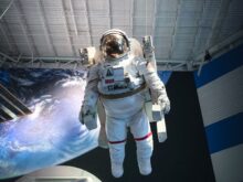 man in white and black suit standing on white and blue floor
