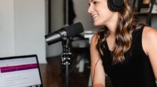 woman in black tank top sitting on chair in front of microphone