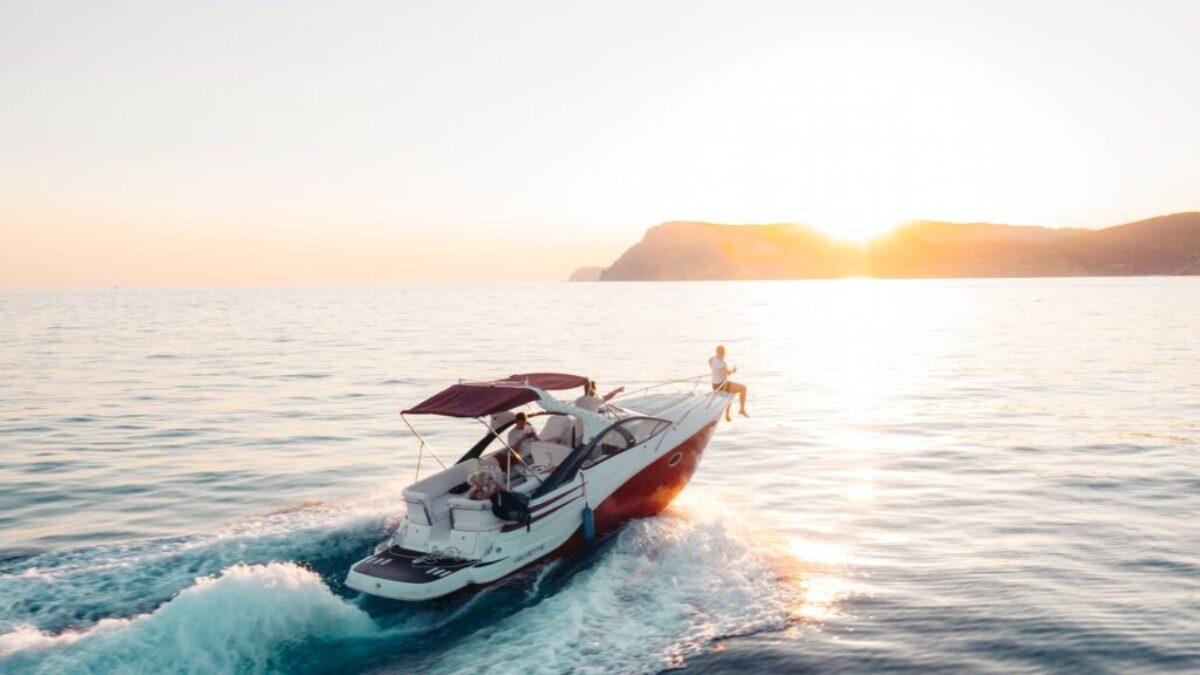 man riding on white and red boat on sea during daytime