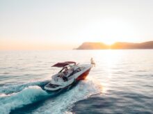 man riding on white and red boat on sea during daytime