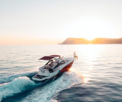 man riding on white and red boat on sea during daytime