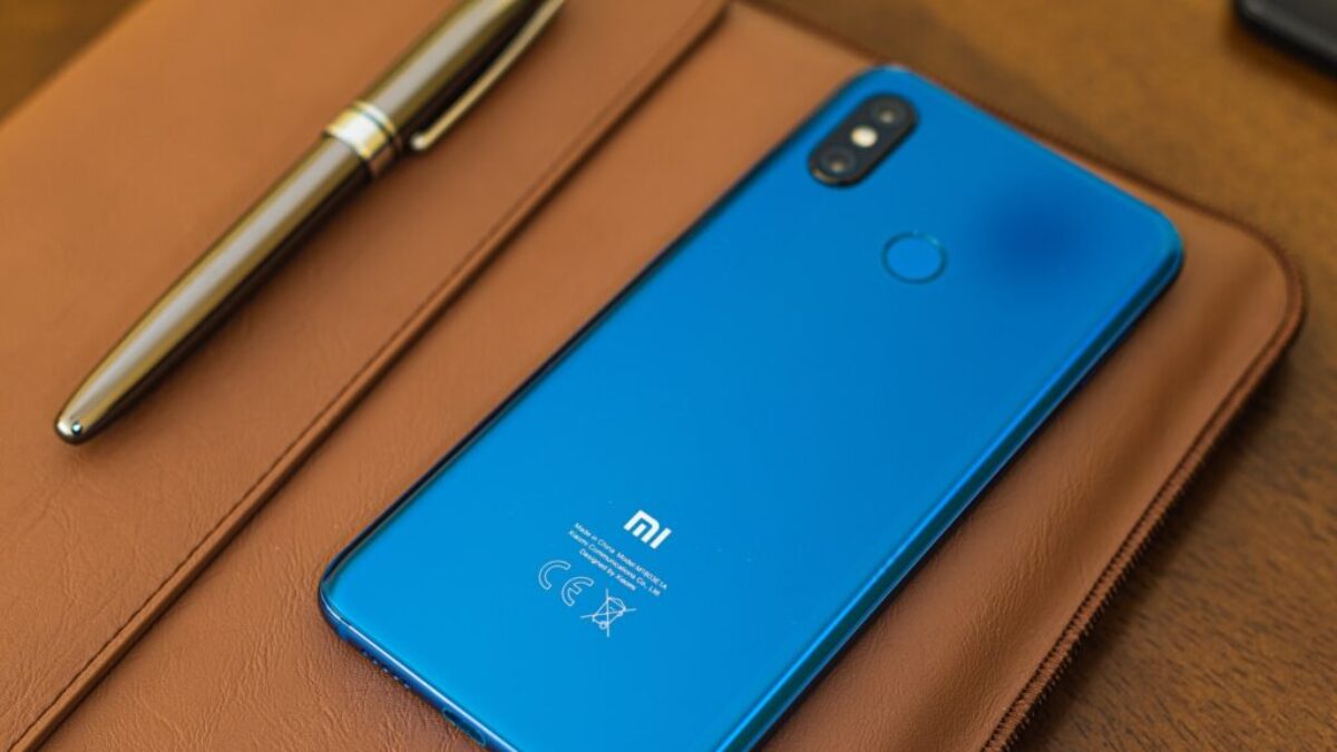 shallow focus photo of blue Xiaomi smartphone