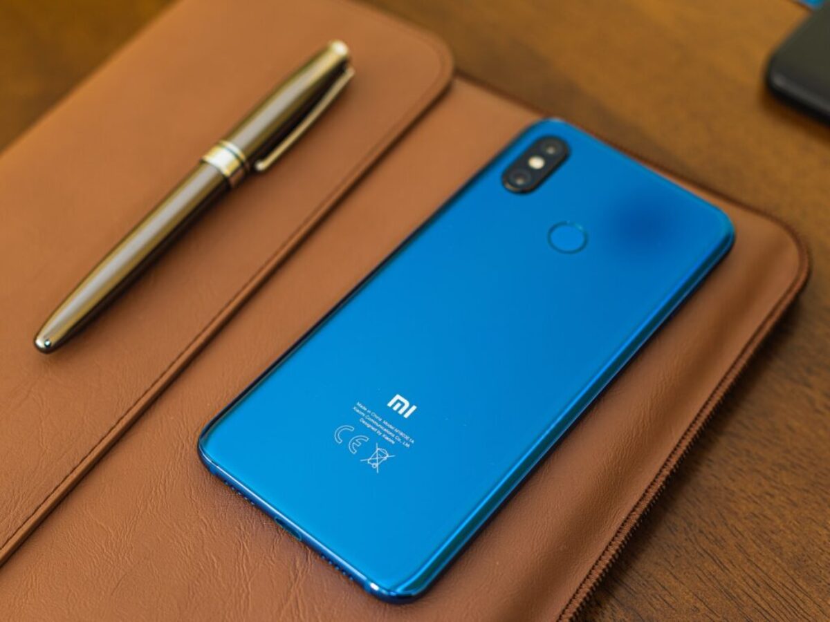shallow focus photo of blue Xiaomi smartphone