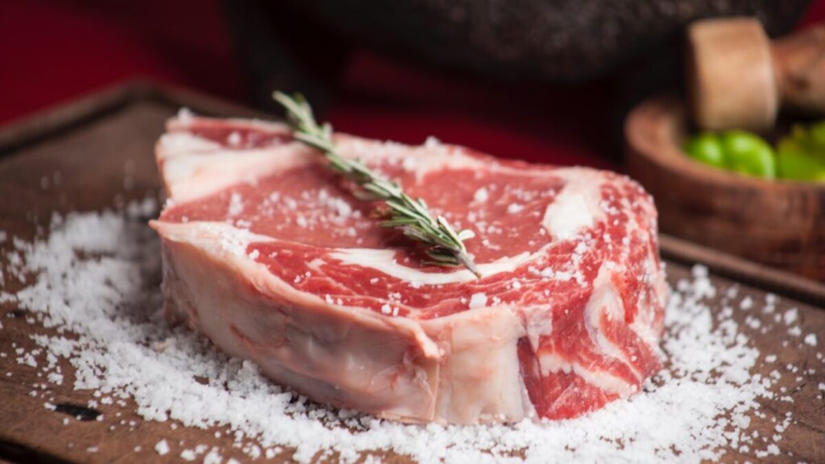 raw meat on brown wooden chopping board