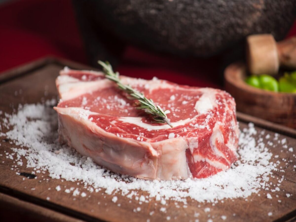 raw meat on brown wooden chopping board