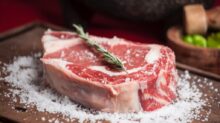 raw meat on brown wooden chopping board