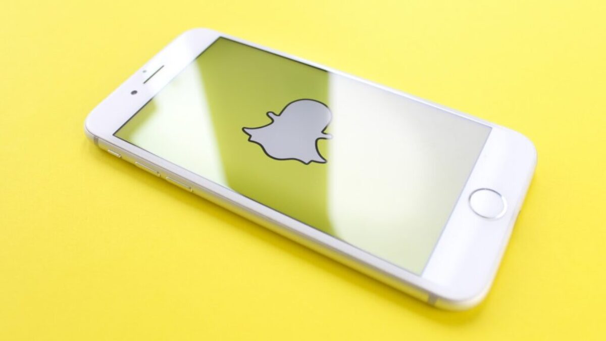 silver iPhone 6 on top of yellow wooden surface