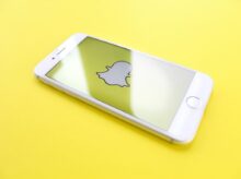 silver iPhone 6 on top of yellow wooden surface