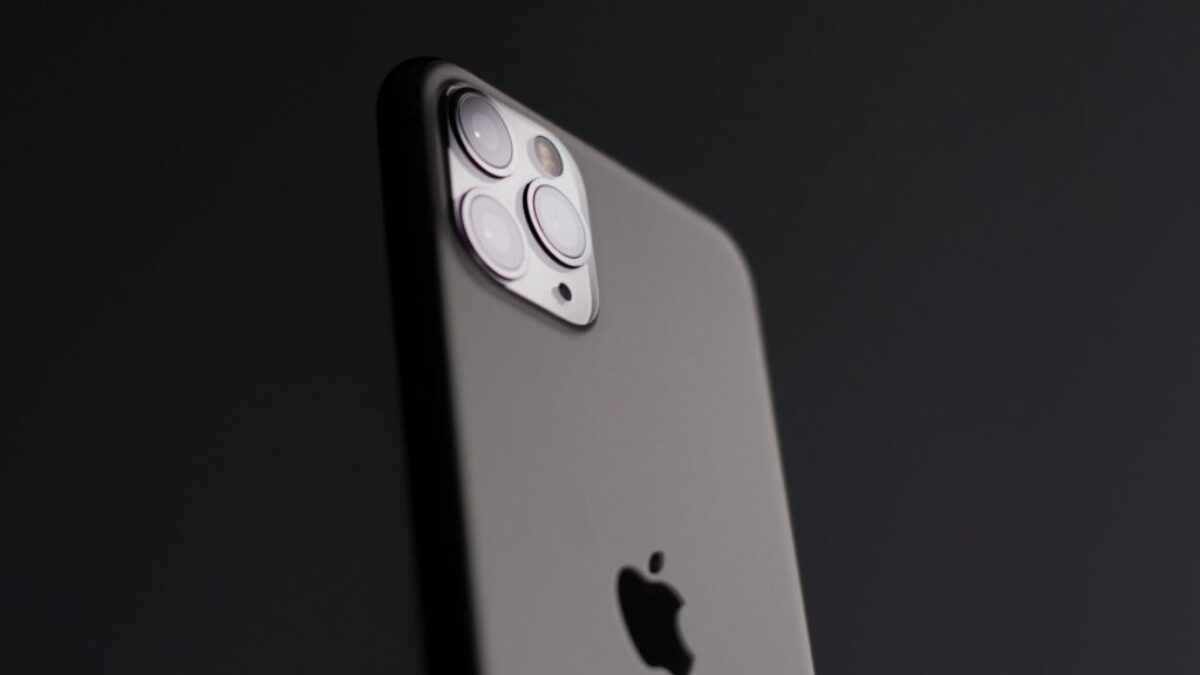 silver iphone 5s on black surface
