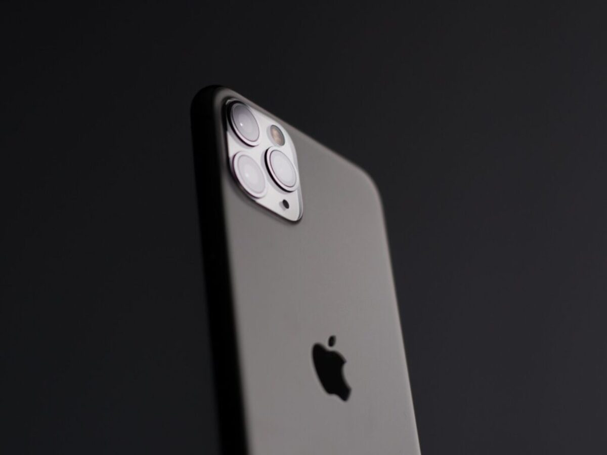 silver iphone 5s on black surface