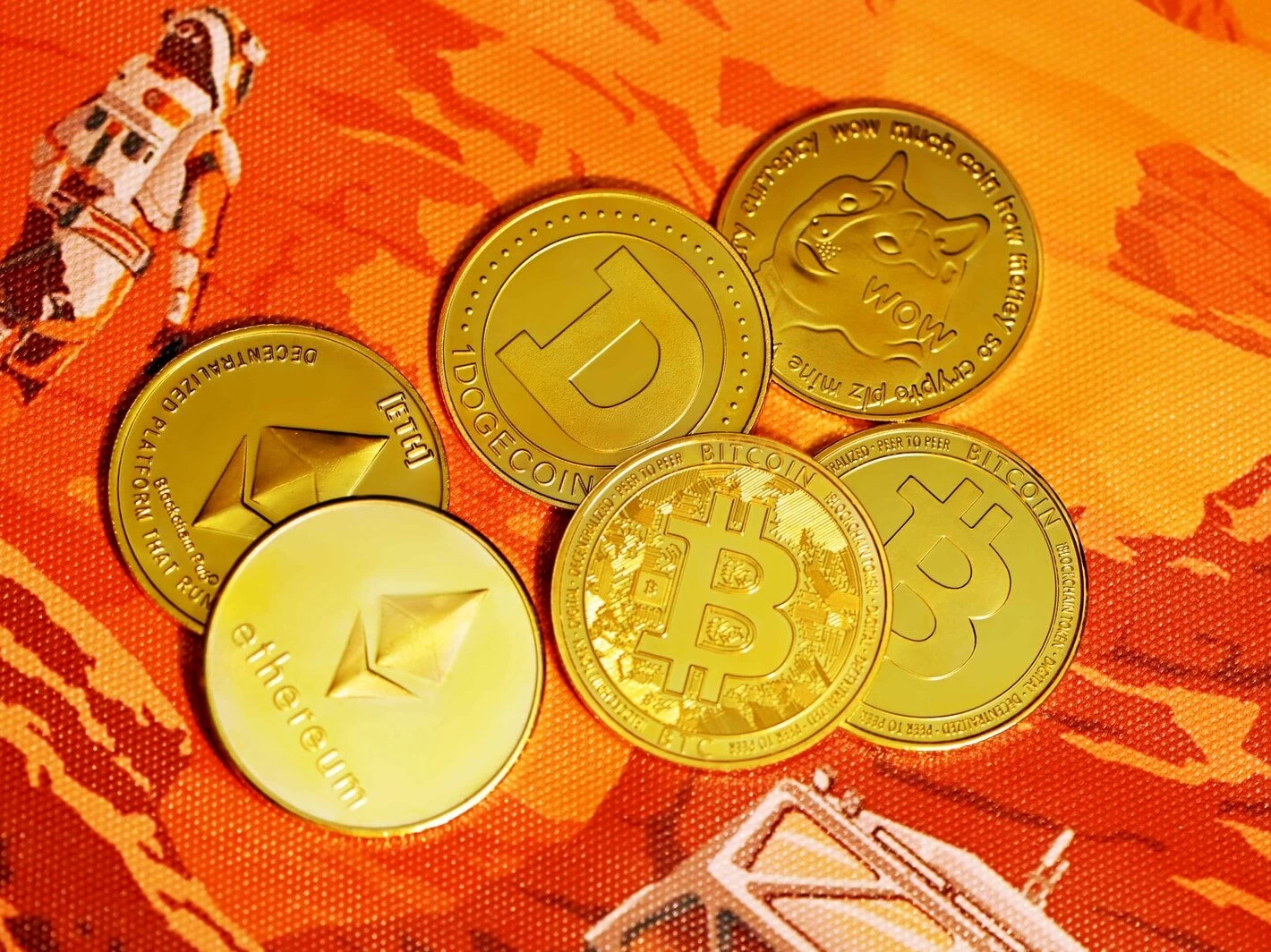 gold round coins on red textile
