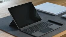 black and silver laptop computer on brown wooden table