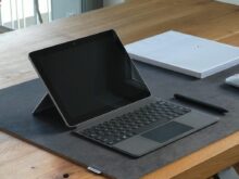 black and silver laptop computer on brown wooden table