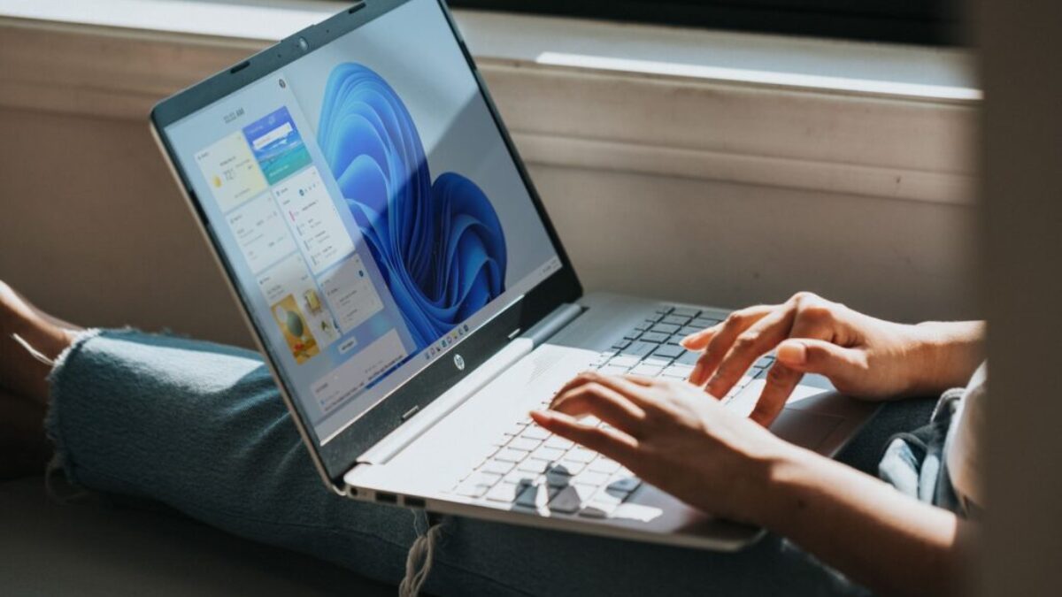 person using macbook pro on lap