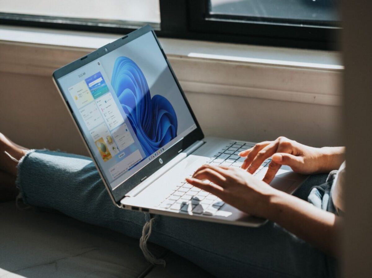 person using macbook pro on lap