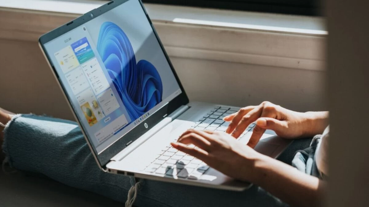 person using macbook pro on lap