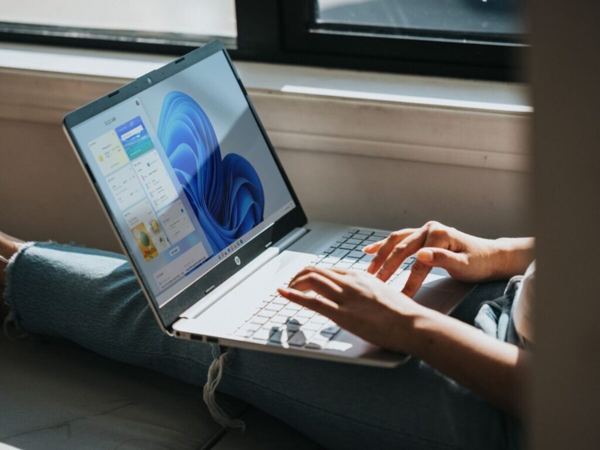 person using macbook pro on lap