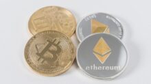 four round silver-colored and gold-colored Bitcoins
