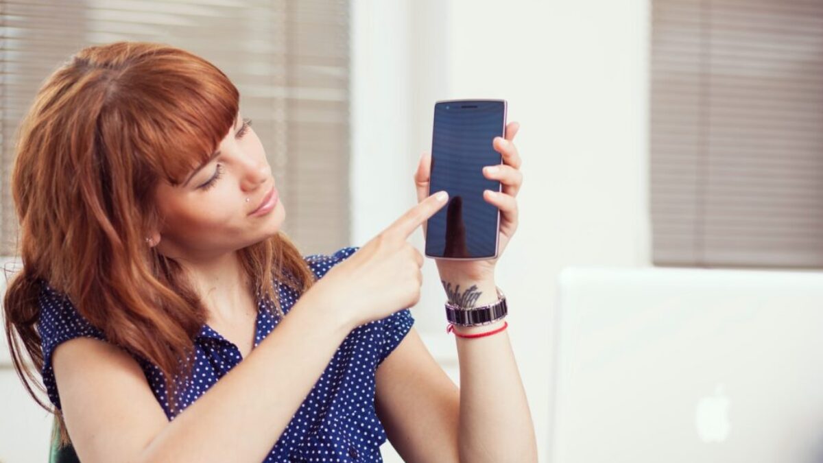 woman holding an Android smartphone