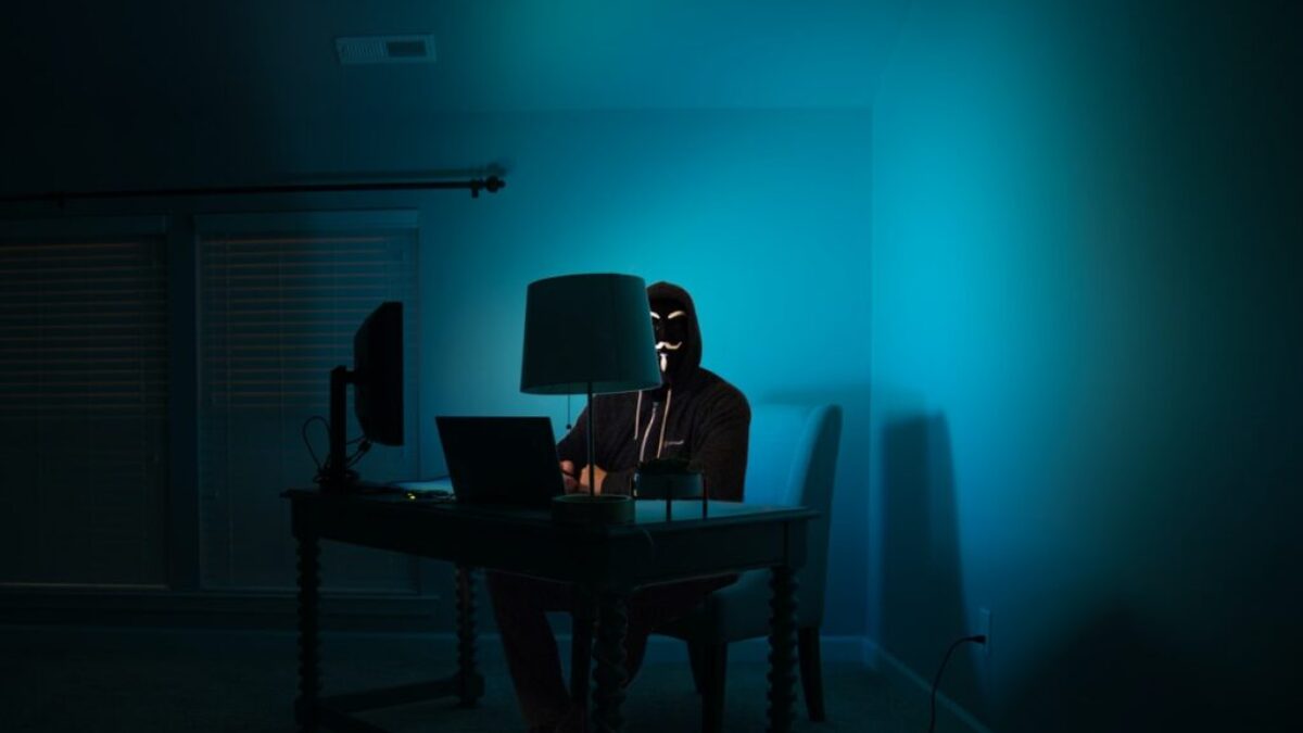 man siting facing laptop