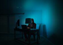 man siting facing laptop