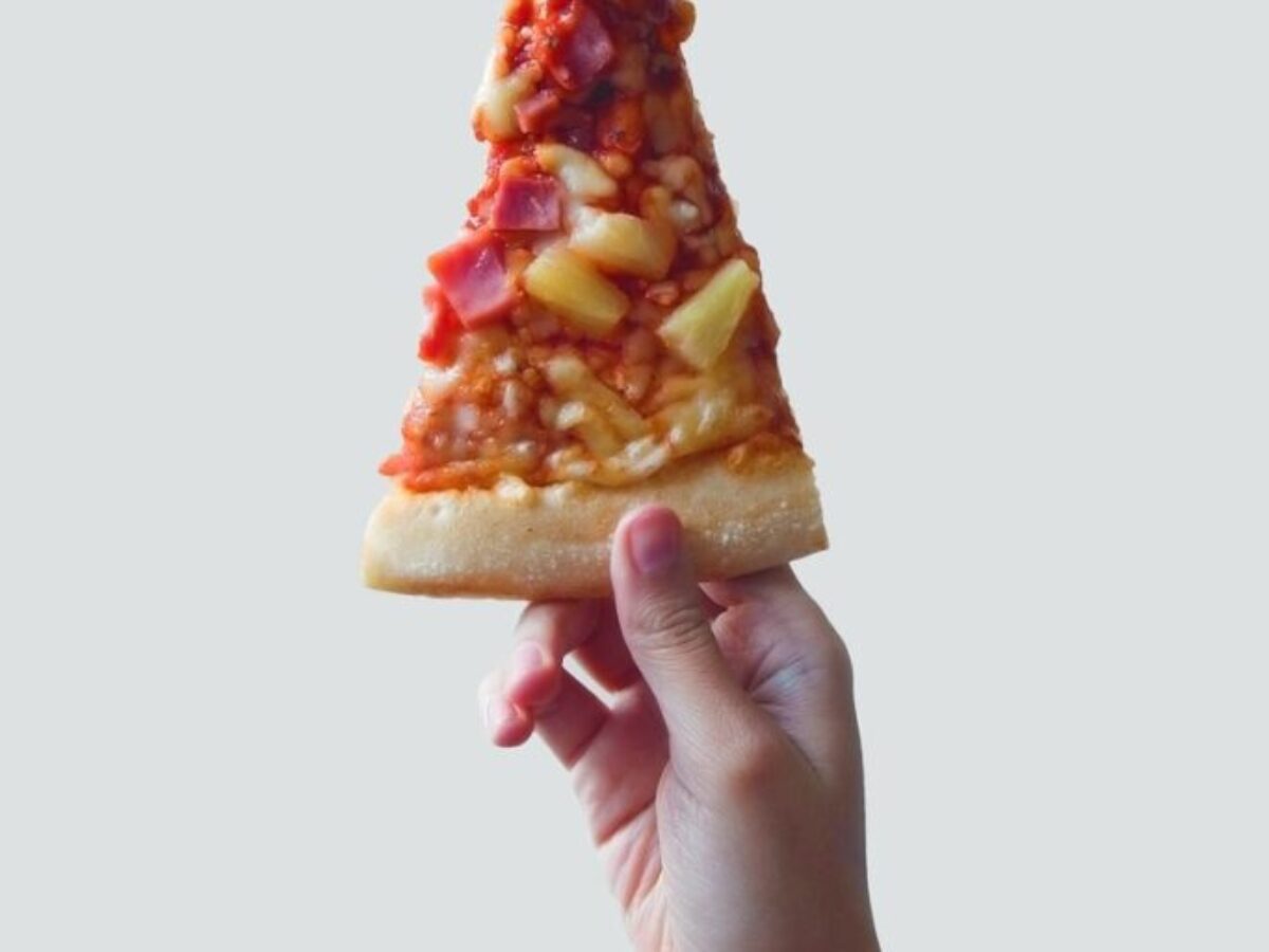person holding sliced pizza