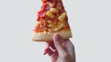 person holding sliced pizza