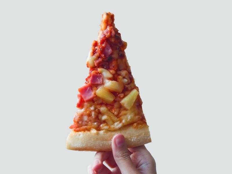 person holding sliced pizza
