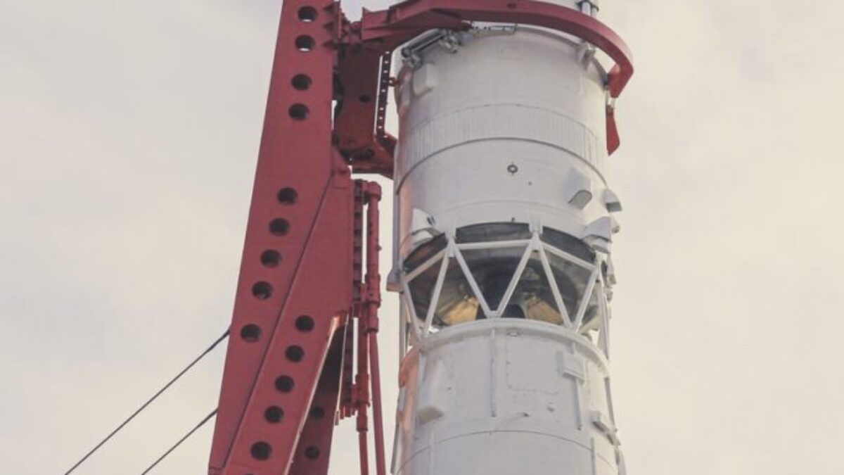 white and red lighthouse under white clouds during daytime