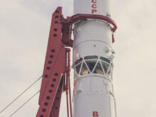white and red lighthouse under white clouds during daytime