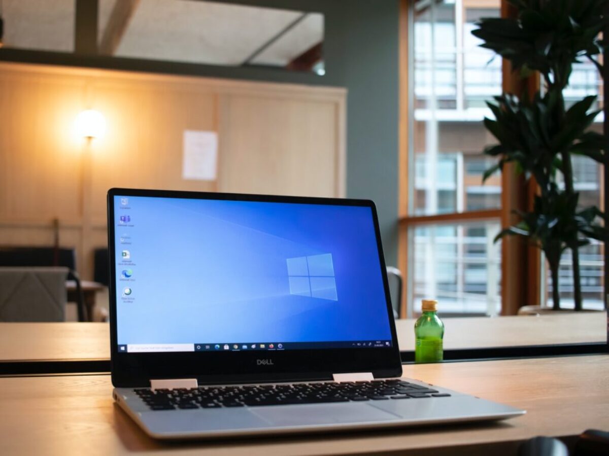 black and gray asus laptop computer on brown wooden table