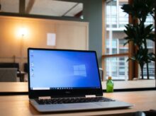 black and gray asus laptop computer on brown wooden table